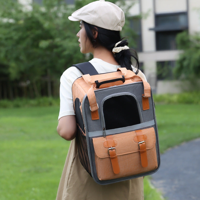 Brighty UrbanCarry – Woman wearing breathable pet backpack carrier in Orange colorway on her back, showing adjustable shoulder straps, outdoor setting