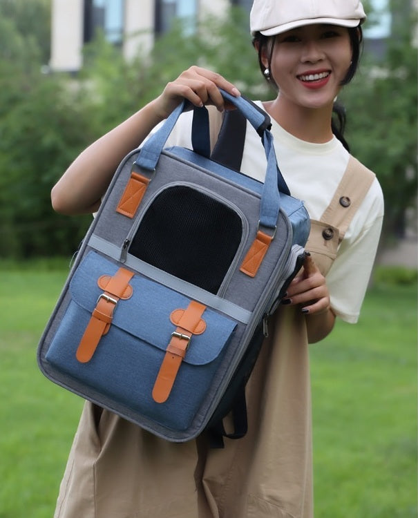 Brighty UrbanCarry – Woman holding breathable pet backpack carrier in Blue colorway, showing front mesh window and leather buckles, outdoor setting