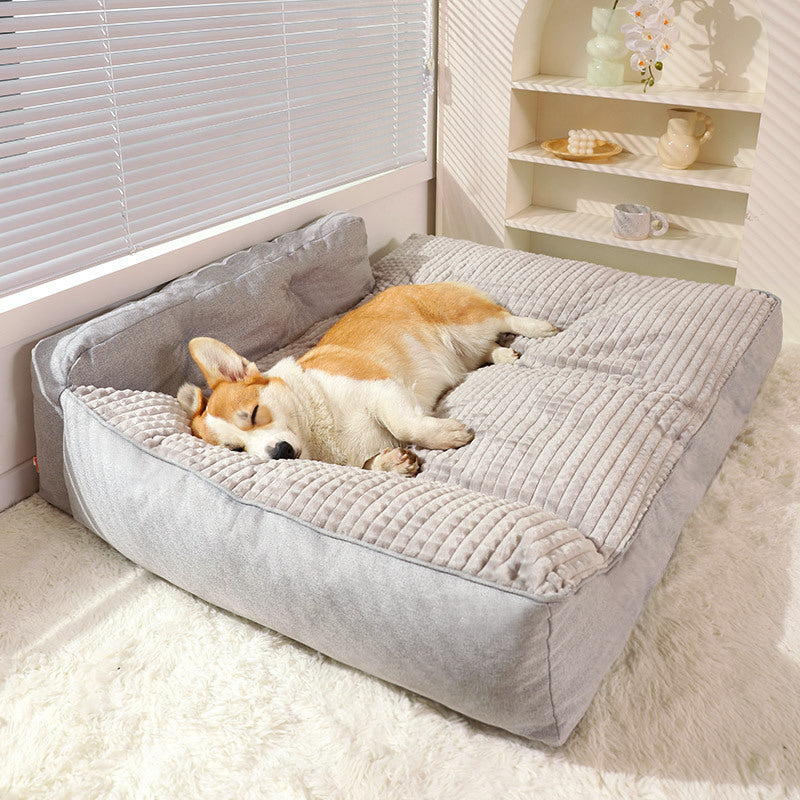 Corgi resting on Brighty CozyHaven sofa dog bed with soft padded edges, grey color