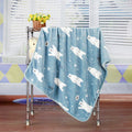 Brighty BearHug soft fleece blanket in blue with polar bear and snowflake print, hanging display