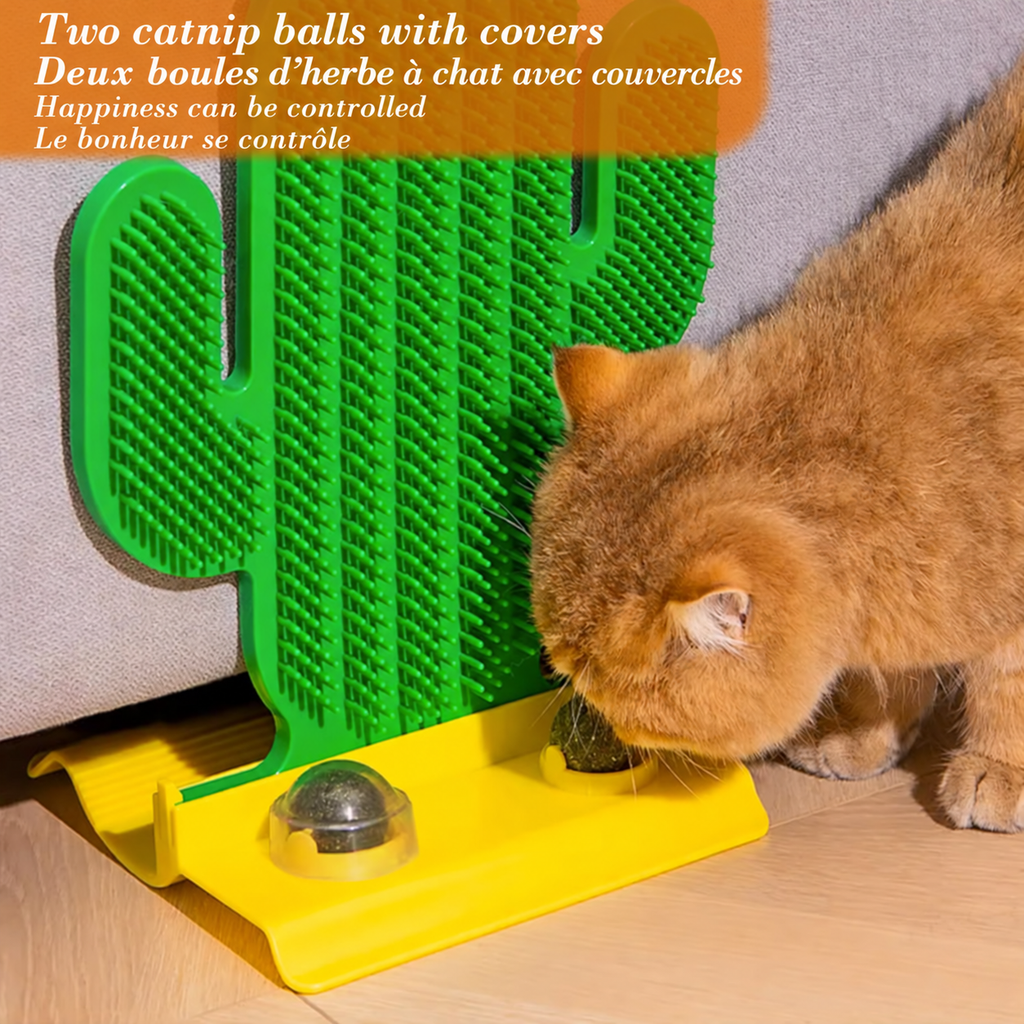 Orange cat exploring a catnip ball on the yellow base of the green Brighty CactusCare brush, with the second ball beneath a clear cover.
