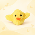 Front view of the yellow Brighty FlappyDuck with raised wings, black eyes and an orange beak against a pale yellow duck-patterned background.