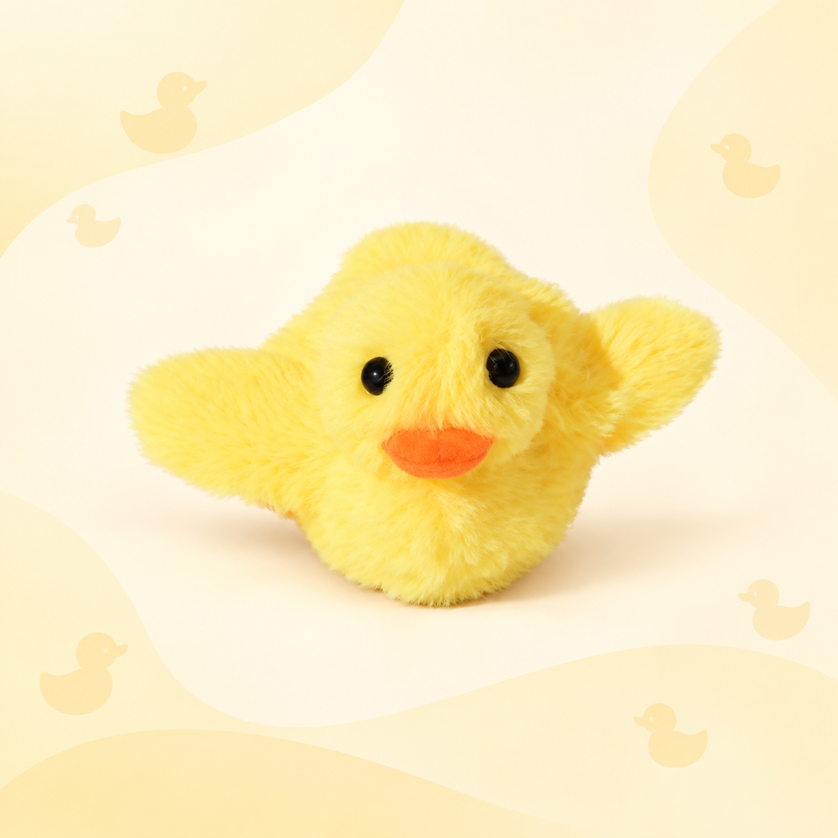 Front view of the yellow Brighty FlappyDuck with raised wings, black eyes and an orange beak against a pale yellow duck-patterned background.