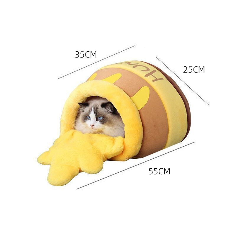 Cat resting inside the yellow and brown Brighty HoneyNest cat bed, with small-size exterior dimensions of 55 × 35 × 25 cm.