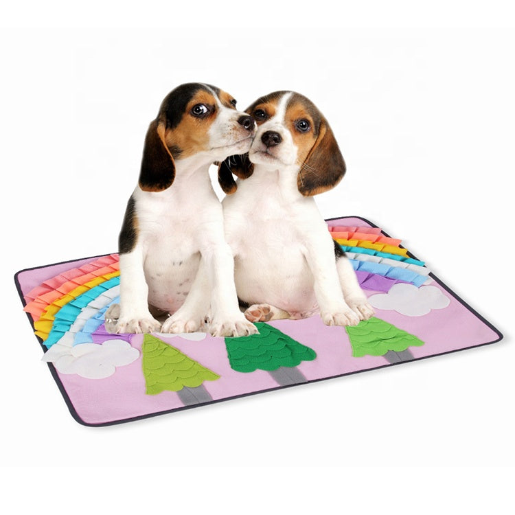 Two beagle puppies sitting on the Brighty Hunt & Sniff snuffle mat in rainbow forest design