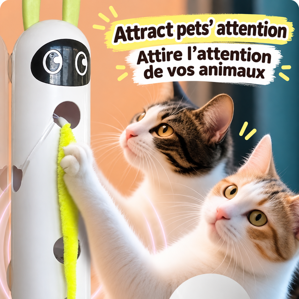 Two cats watching and reaching for the yellow-green tail of a white Brighty Peekaboo attached to a vertical surface.