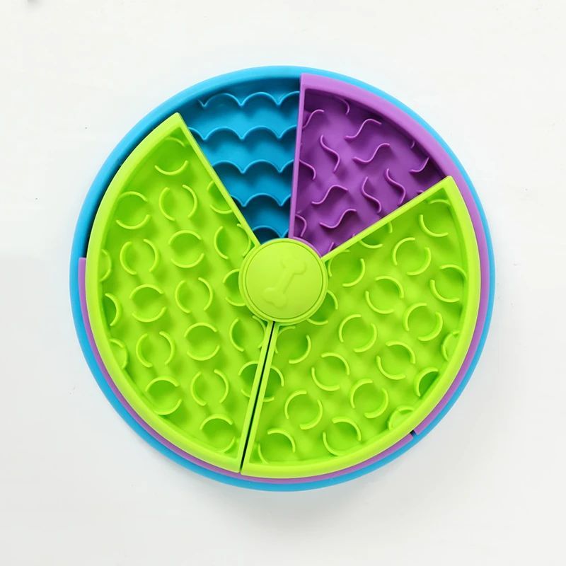 Top-down view of the blue, purple and green puzzle feeder, showing its rotating sections and textured compartments.