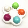 Brighty TreatQuest slow feeder puzzle with 5 colorful lids closed over hidden treat compartments