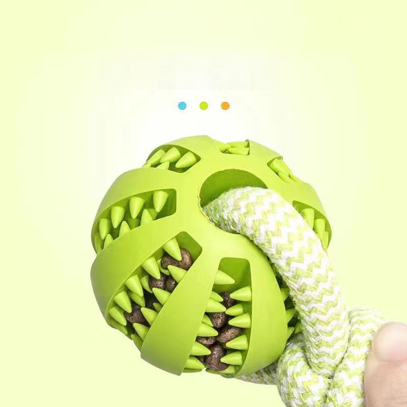 Close-up of the green Brighty TugBall showing treats tucked between the textured ridges and a green-and-white rope threaded through the ball.