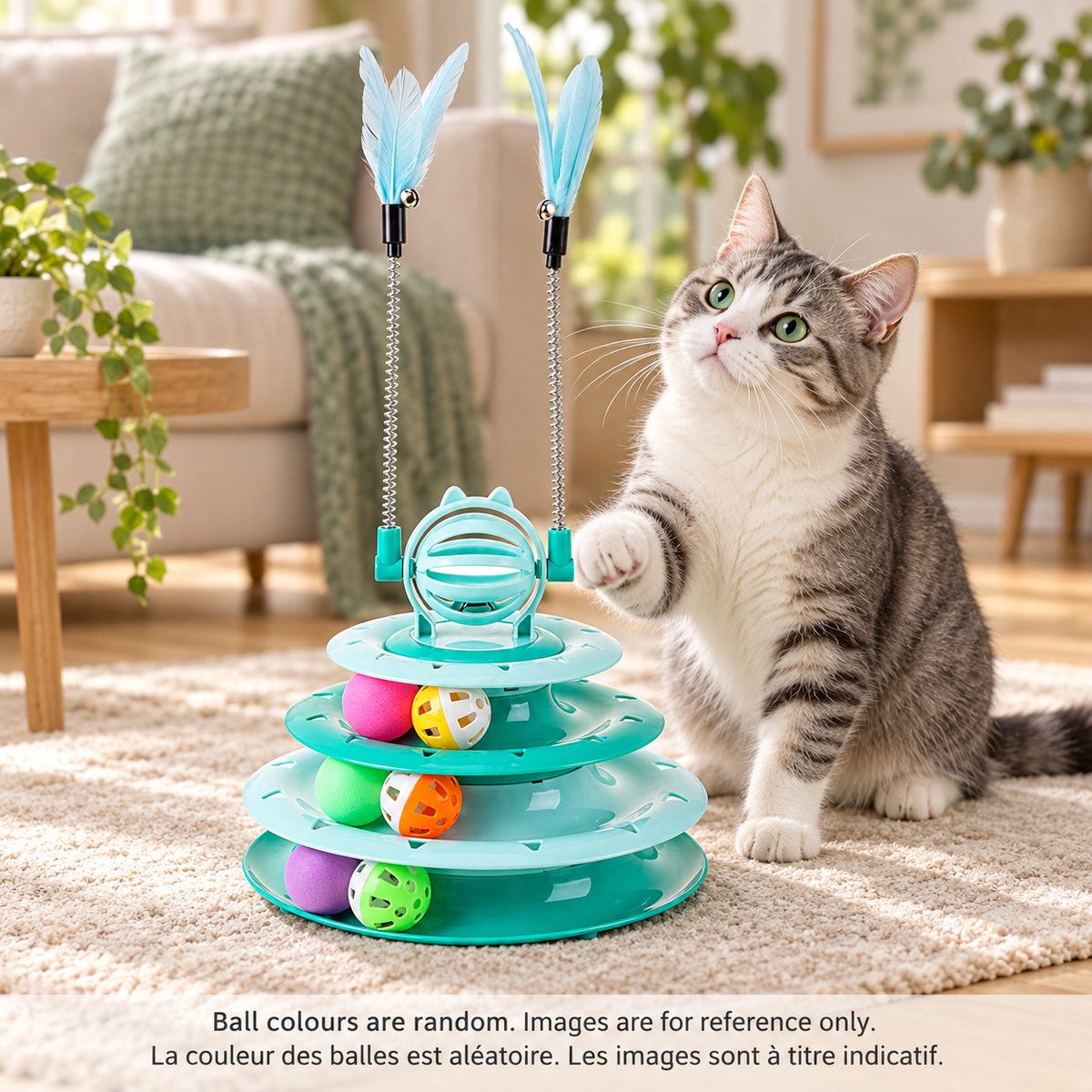 Grey and white tabby cat raising a paw beside a green Brighty TwirlTower with three ball tracks, six balls and two spring-mounted feather rods.