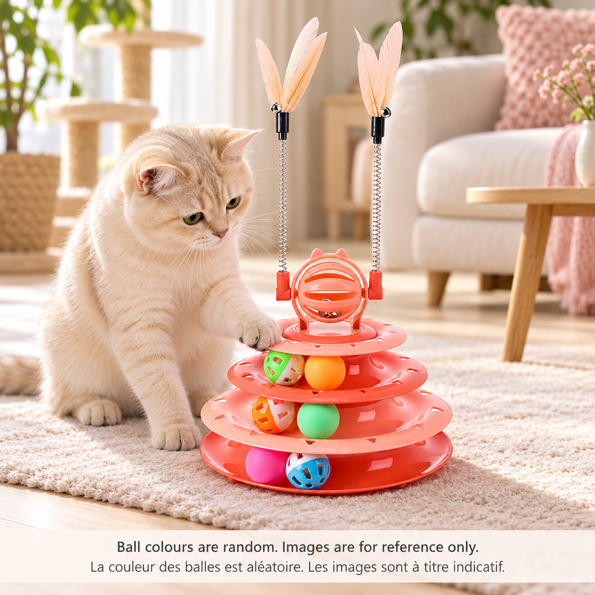 Cream-coloured cat touching a ball in a pink Brighty TwirlTower, with three ball tracks, six balls, a spinning bell ball and two spring-mounted feather rods.