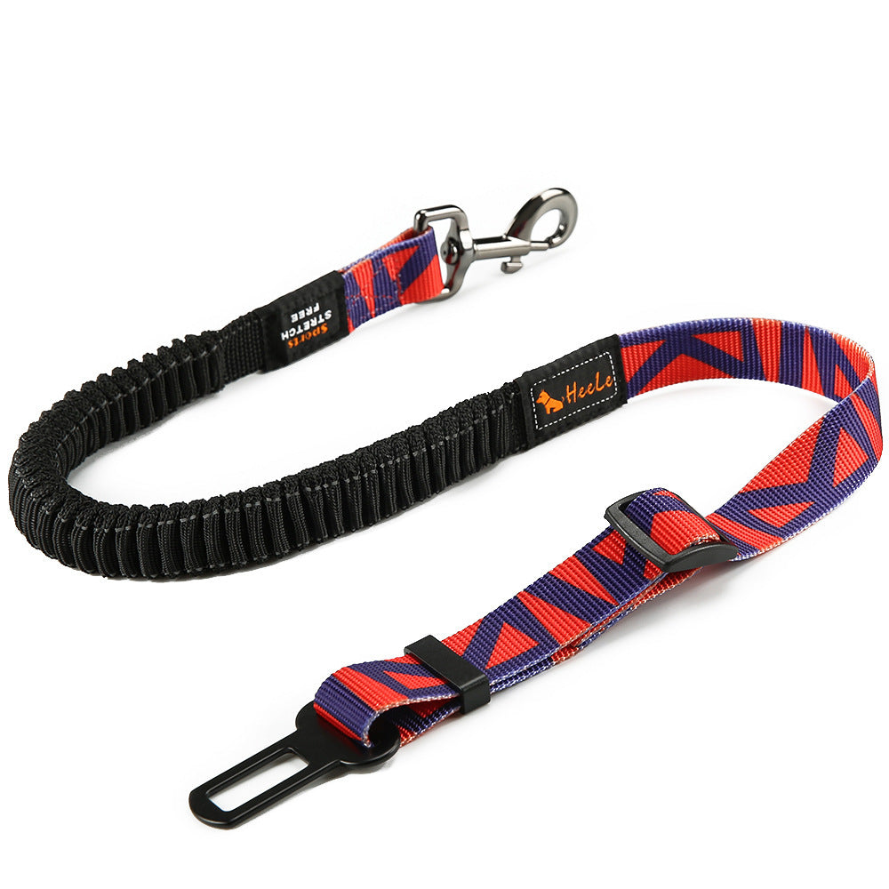 Red and navy blue HEELE RoadFlex dog car tether with a geometric pattern, elastic section, swivel clip, adjustable strap and seat belt tab.
