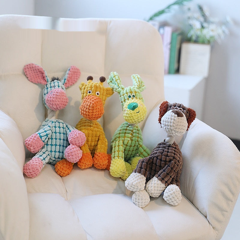 Brighty Soft ChatterPals – Collection of 4 squeaky plush dog toys on a chair, blue donkey, yellow giraffe, green dog and brown dog