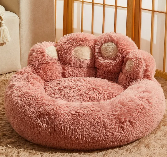 Pink calming dog bed with paw-shaped design and raised edges for anxiety relief and comfort